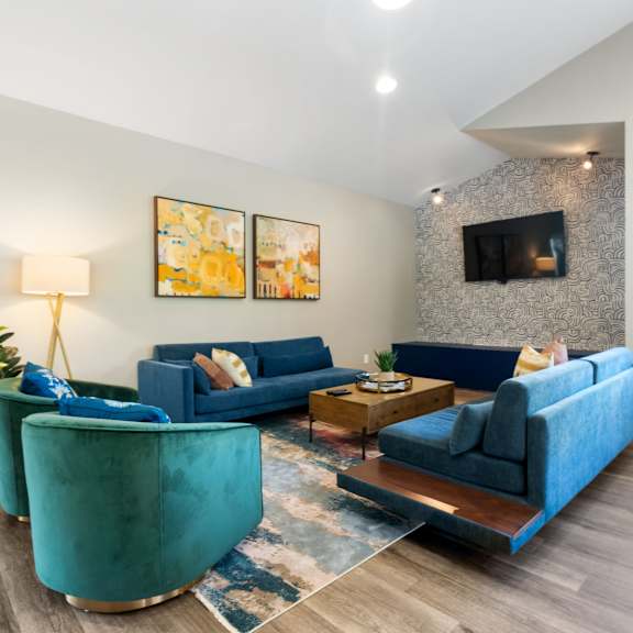 a living room with blue couches and a fireplace.