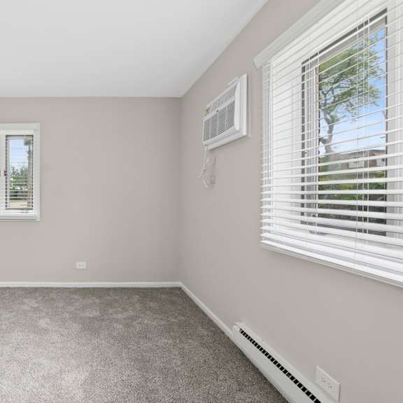 a bedroom with a window and a door.