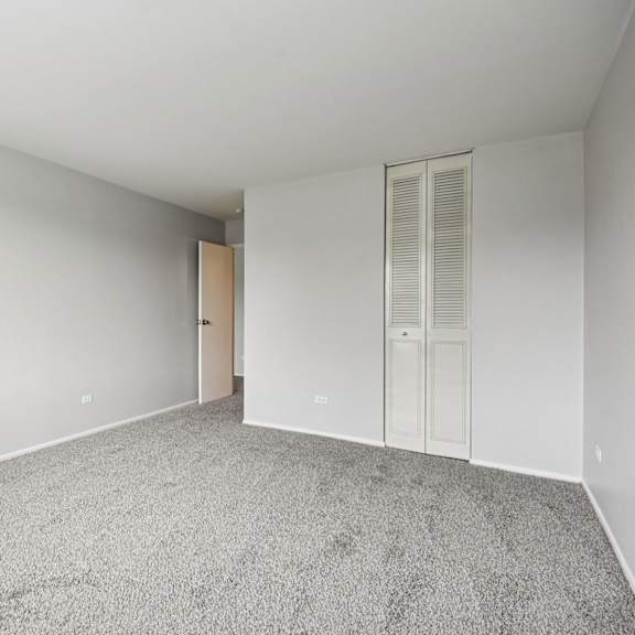 a room with a carpeted floor and white walls.