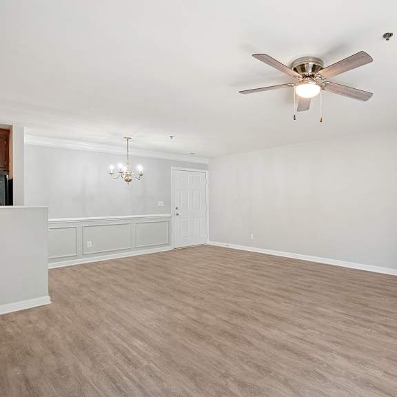a room with a ceiling fan and light fixture.