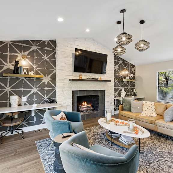 interior club room with sitting area and fireplace  at ascent at farmington hills, farmington hills, mi