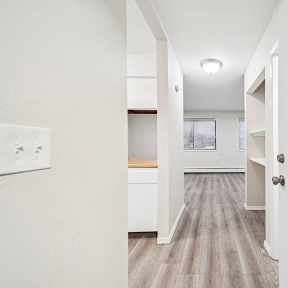 a hallway with a white door on the right and a number 2 on the door.