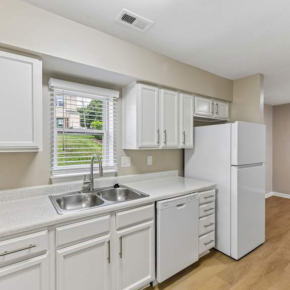 a kitchen with white cabinets and appliances.