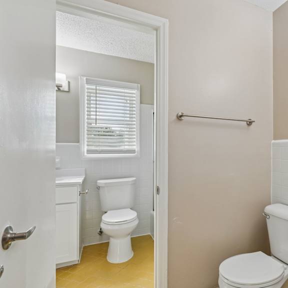 a white toilet and sink in a bathroom.