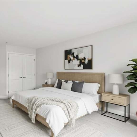 a bedroom with a large bed, a wooden nightstand, and a painting on the wall.