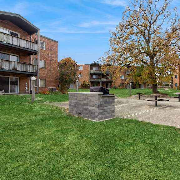 our apartments have a park with a picnic table and a fire pit at river oaks, north aurora, illinois