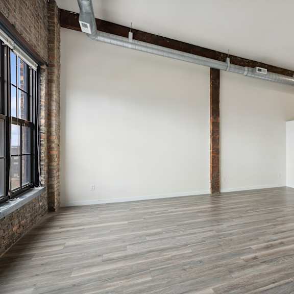 an empty room with white walls and wood floorsat gaar scott historic lofts, minneapolis, 55401