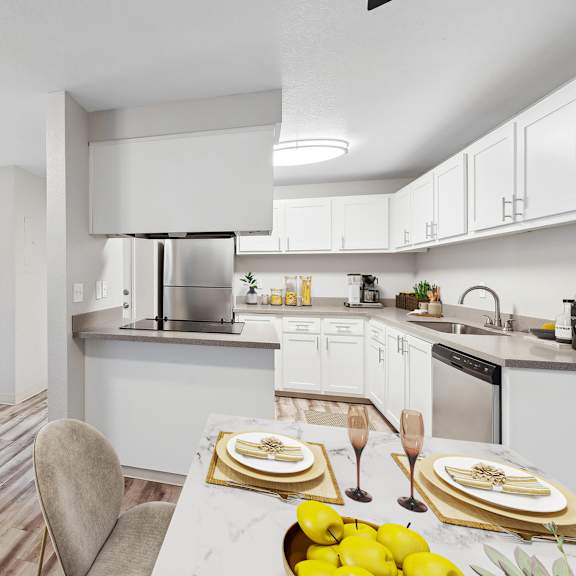 a modern kitchen with a dining table set for two.