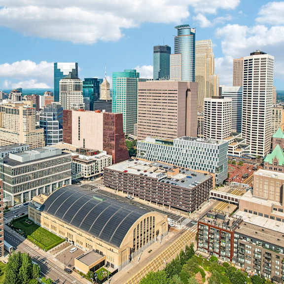 a cityscape with a mix of modern and older buildings under a clear sky.