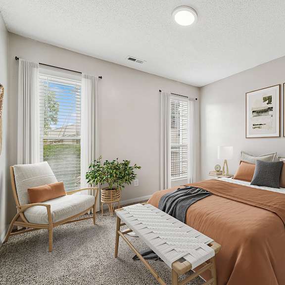 a bedroom with a bed, chair, and window.