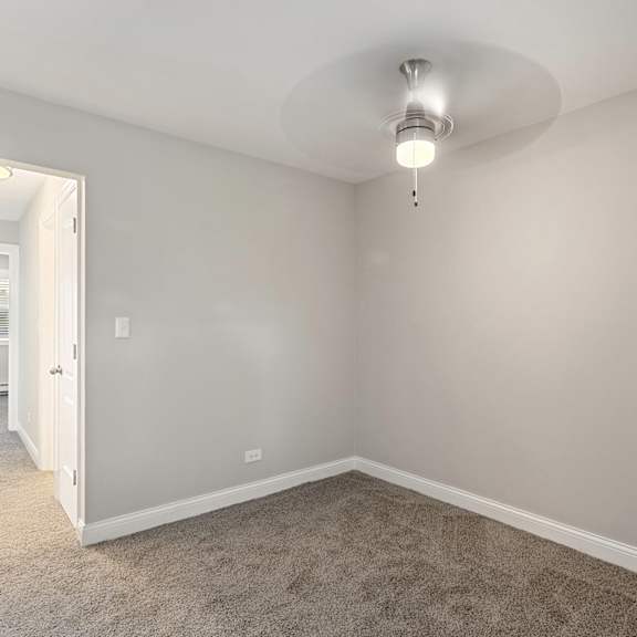 a bedroom with gray walls and carpet at the hinsdale, illinois