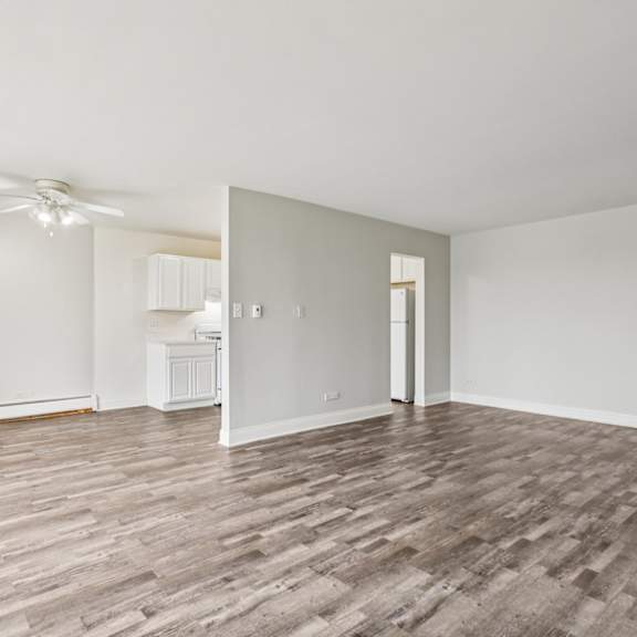 a room with wooden flooring and a ceiling fan.