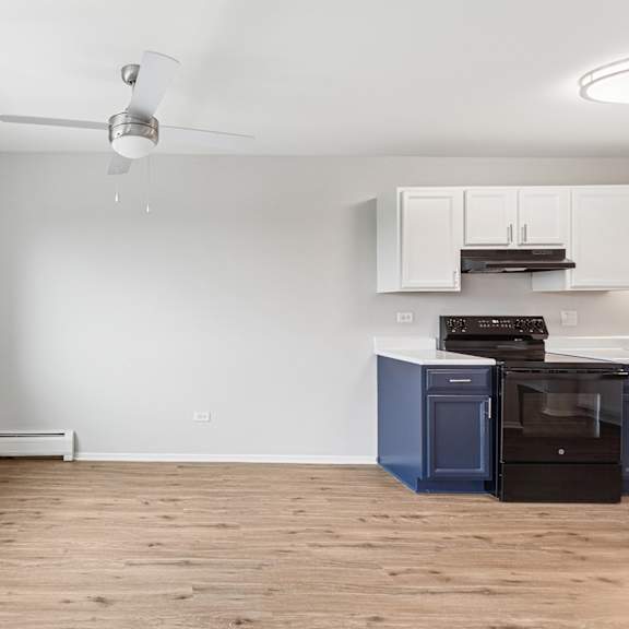 a kitchen with a blue oven and white cabinets.