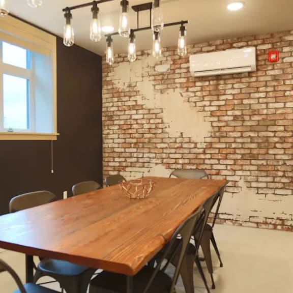 conference room with exposed brick and wood table at brooklyn yard apartments, portland, or 97202