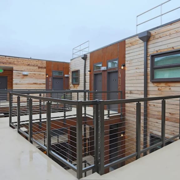 rooftop deck with black metal railings and wood siding at brooklyn yard apartments, portland, oregon