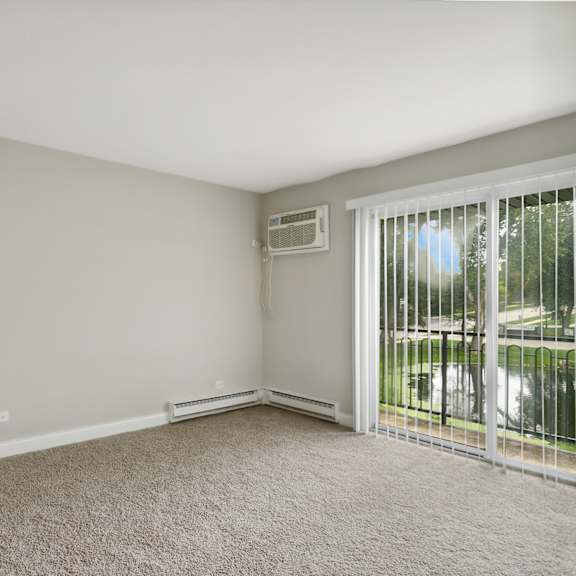 a bedroom with a sliding glass door and carpet at the hinsdale, hinsdale, 60521