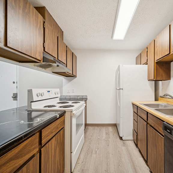 a kitchen with wooden cabinets and stainless steel appliances.
