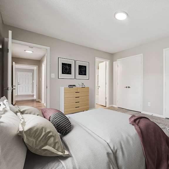 a bedroom with a bed, a dresser, and a wardrobe.