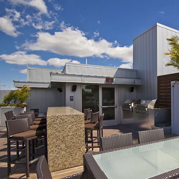 a patio with a table, chairs, and a fireplace.