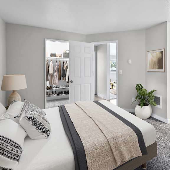 a bedroom with a large bed and a view of a hallway and closet.