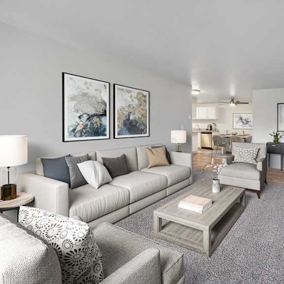 a living room with a grey carpet and a grey couch.