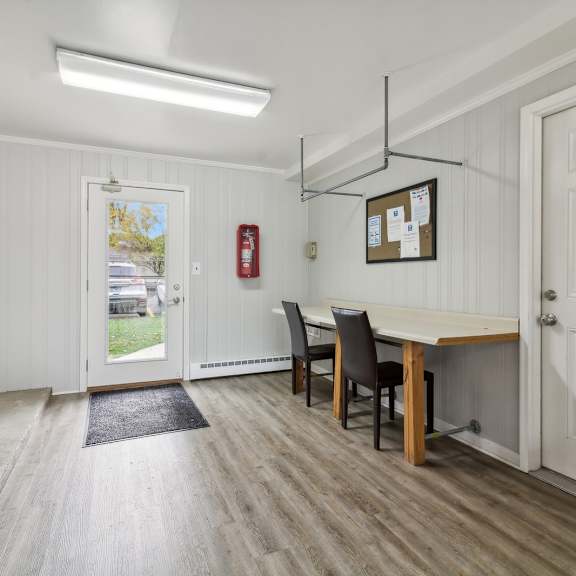 a dining room with a table and chairs and a door at river oaks, illinois