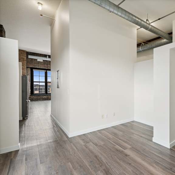 the living room with wood floors and white walls at gaar scott historic lofts, minnesota, 55401