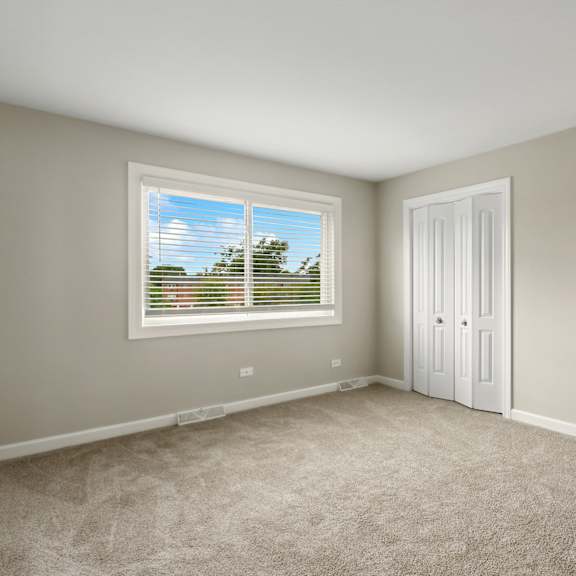 a bedroom with two closets and a window at the hinsdale, hinsdale, 60521