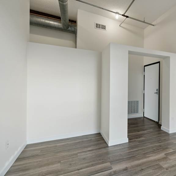 a bedroom with hardwood floors and white wallsat gaar scott historic lofts, minnesota, 55401