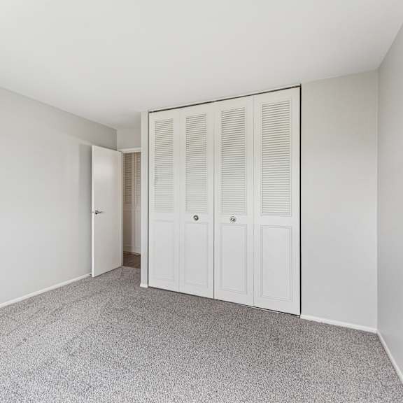 bedroom with carpet and closet doors
