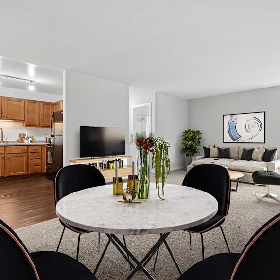 a modern living room with a dining table and chairs.