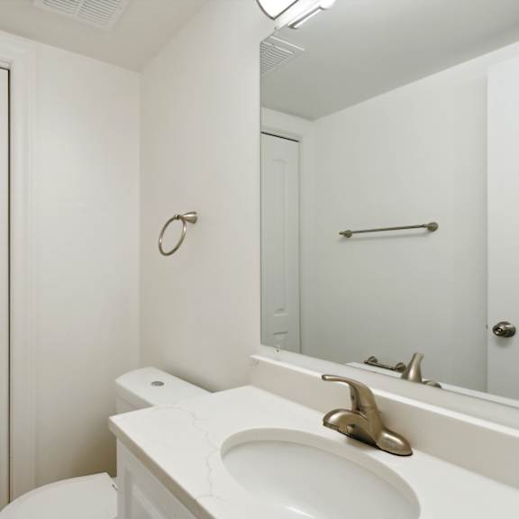 a bathroom with a white sink and toilet next to a white door at the hinsdale, hinsdale, illinois