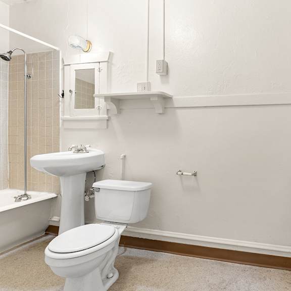 a bathroom with a toilet and mirror.