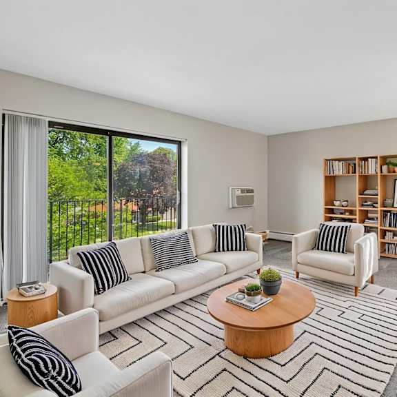 a living room with a white sofa and a wooden coffee table.
