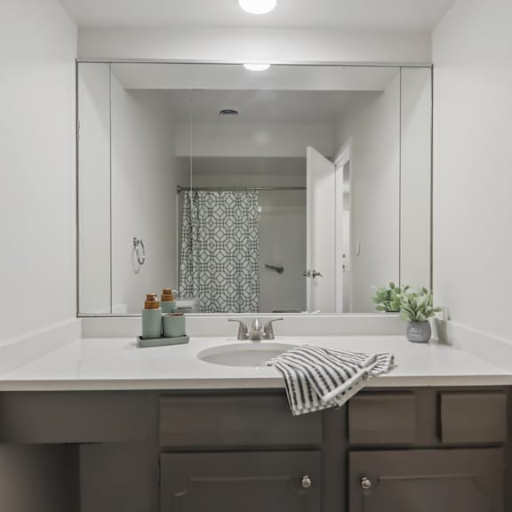 a bathroom with a sink and mirror.