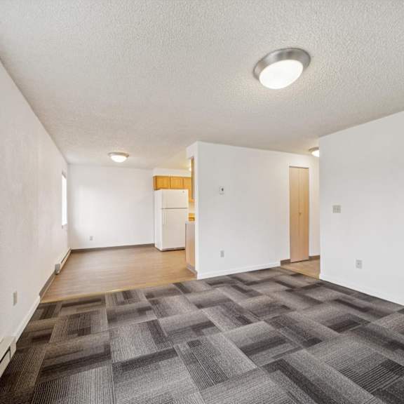 a room with a carpeted floor and a white ceiling.