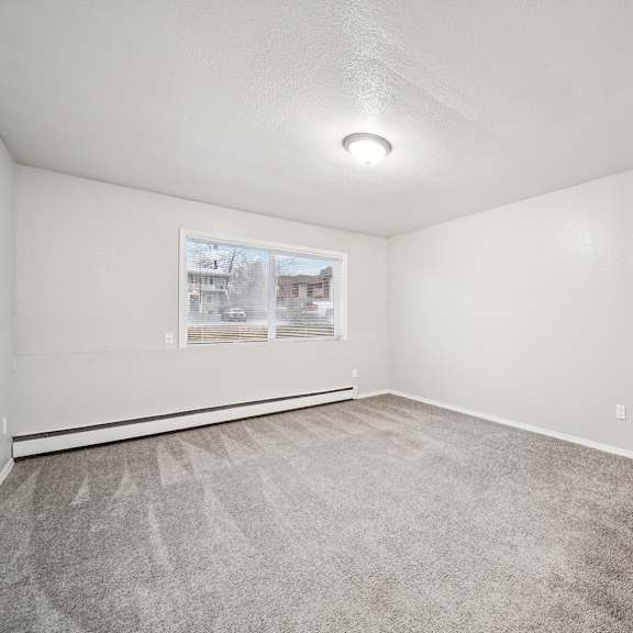 a room with a carpeted floor and a picture on the wall.