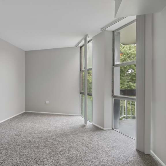 a room with grey carpet and white walls.