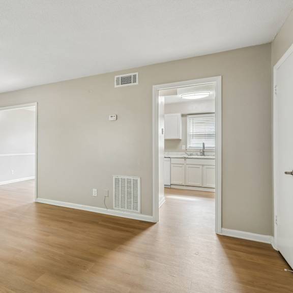 a room with a white door and a window with blinds.
