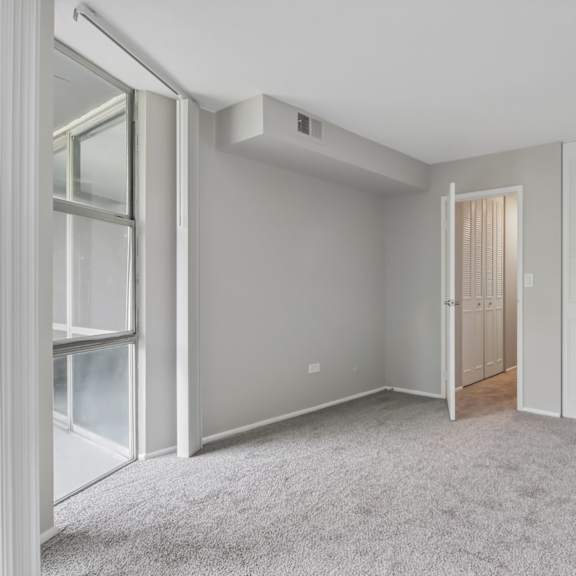 a room with a carpeted floor and white walls.