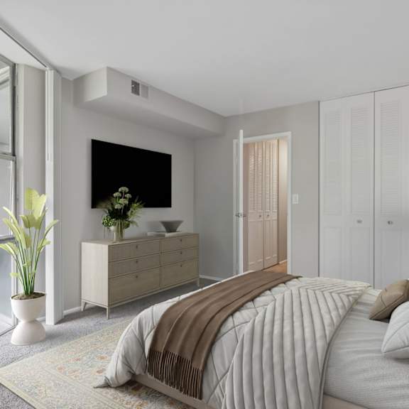 a bedroom with a large bed and a dresser with a plant on top.