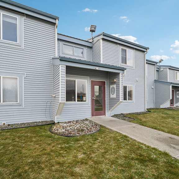 a row of houses with a red door in the middle.