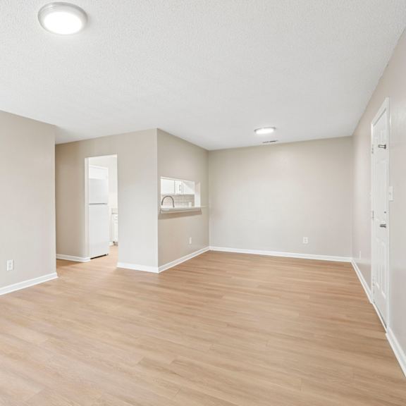 a room with wooden flooring and white walls.