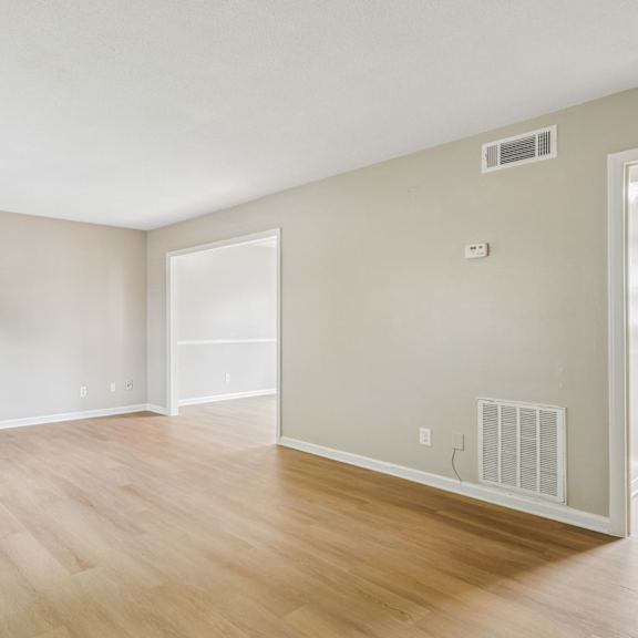 a room with wooden floors and white walls.