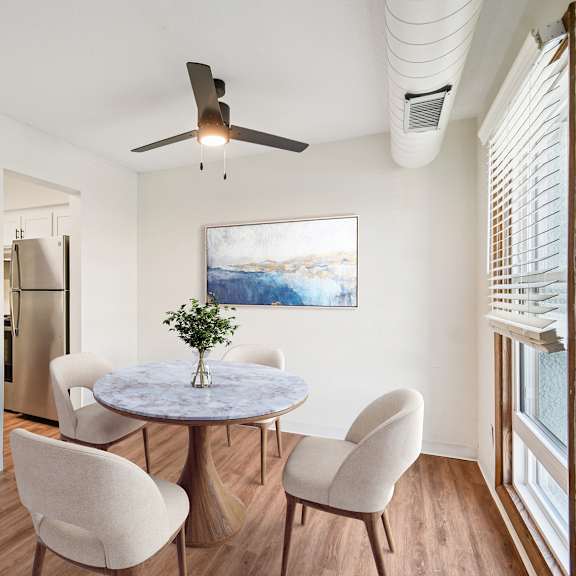 a dining room with a table and chairs.