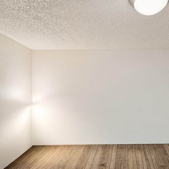 a room with a light on the ceiling and a light on the wall.
