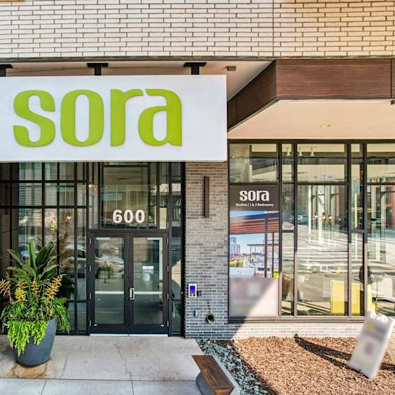 the image shows the front of a building with a sign that reads "sora 600".