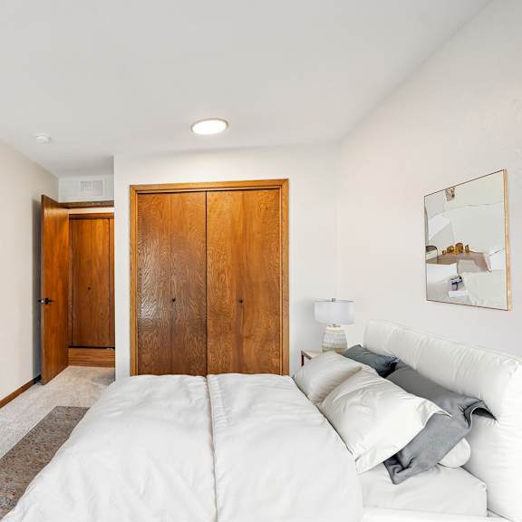 a bedroom with a bed, a dresser, and a mirror.