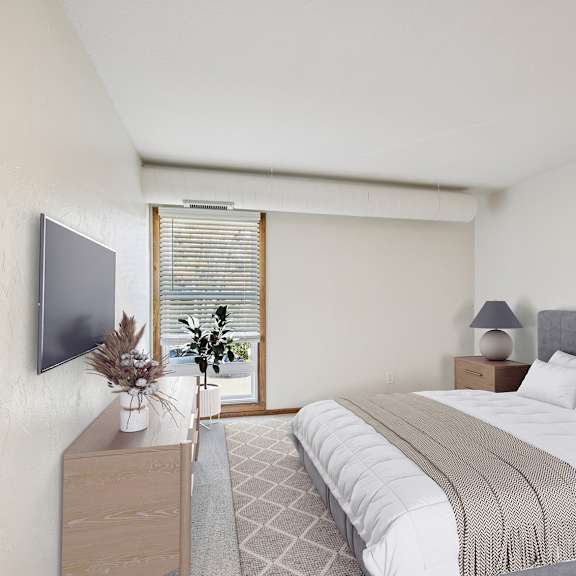 a bedroom with a large bed and a television on the wall.