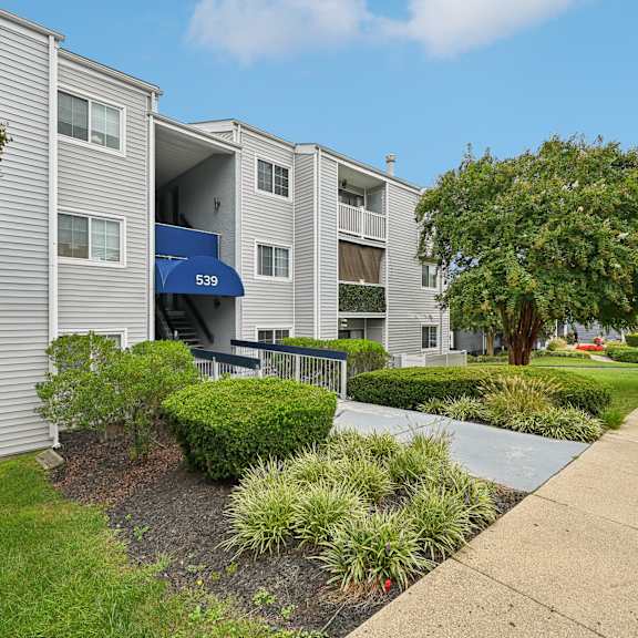 exterior view of our apartments with a sidewalk and landscaping in front at renew odenton
